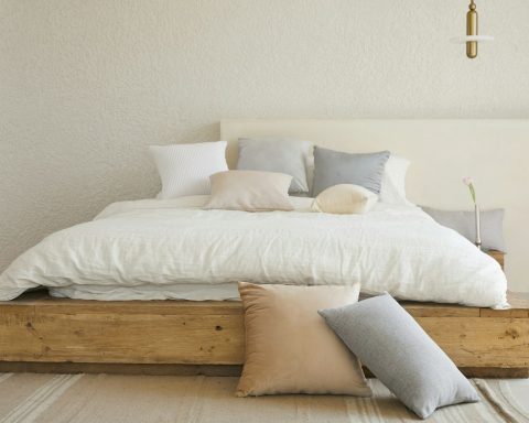 white bed pillow on brown wooden bed frame