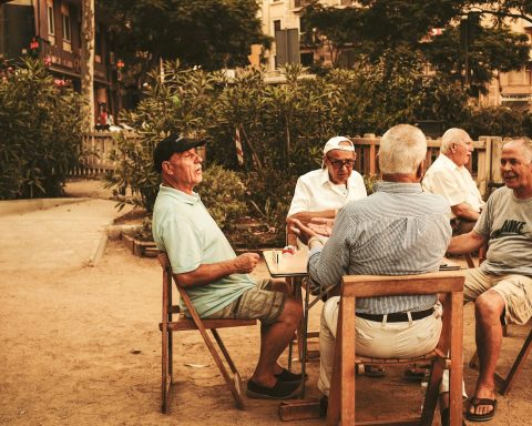 group of old men sitting near table