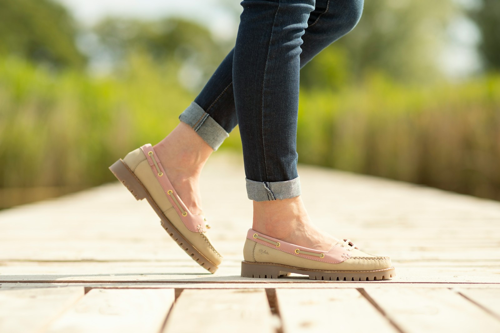 A person walking on a wooden platform in a park