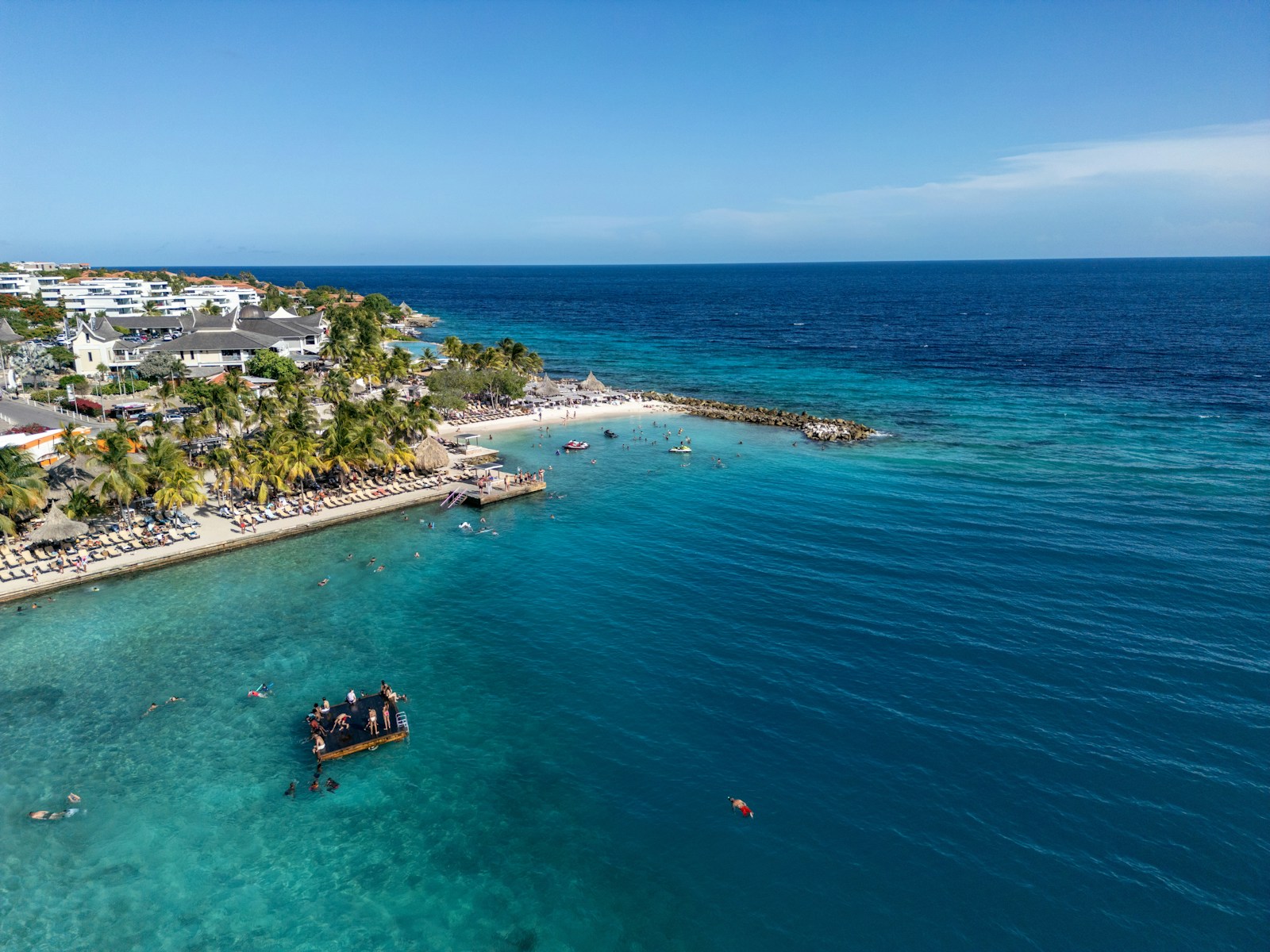 An aerial view of a beach with a boat in the water