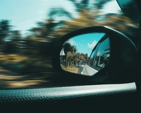 car side mirror with a reflection of sun