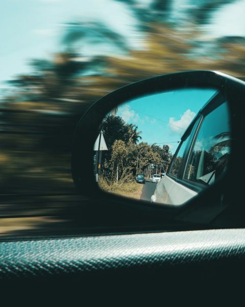 car side mirror with a reflection of sun