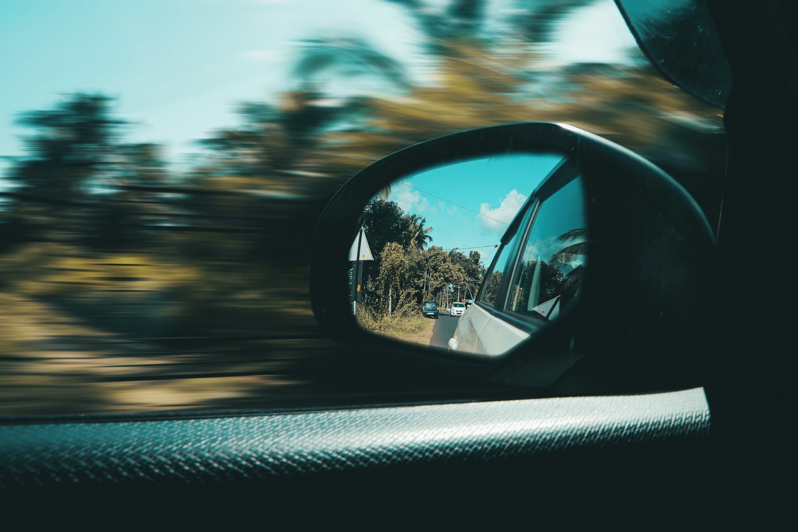 car side mirror with a reflection of sun