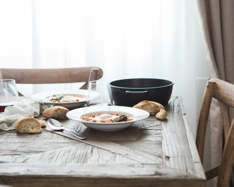 two white ceramic plates on brown wooden table