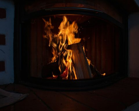 a fire burning inside of a wooden stove