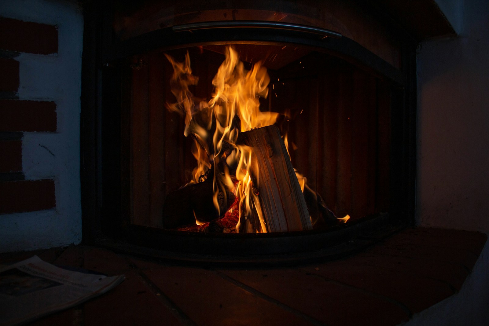 a fire burning inside of a wooden stove