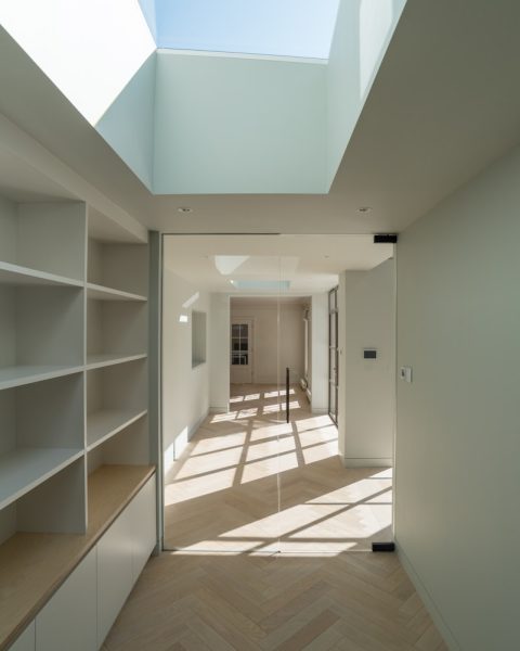 white wooden shelf near white wall