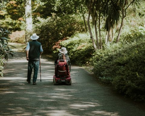 a man and a woman walking down a dirt road