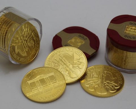 gold round coins on white surface