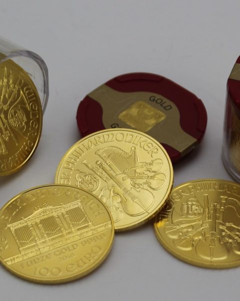 gold round coins on white surface