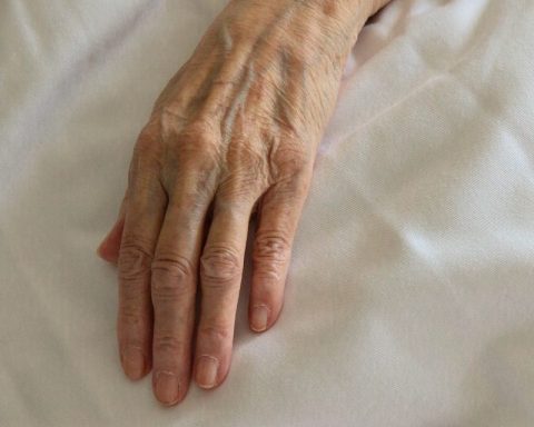 persons left hand on white textile