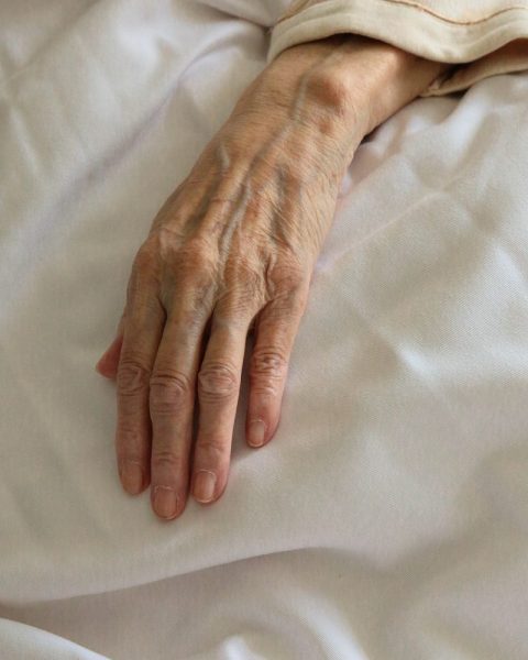 persons left hand on white textile