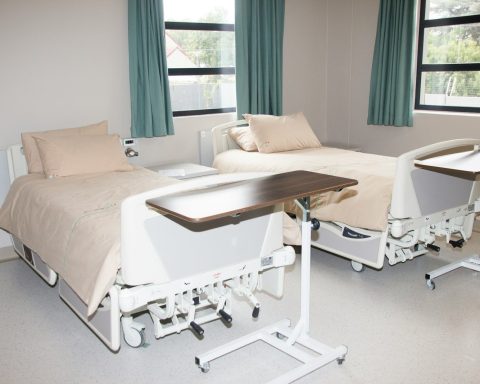 white hospital bed near window
