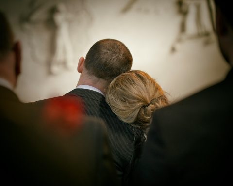 a man and a woman looking at the camera
