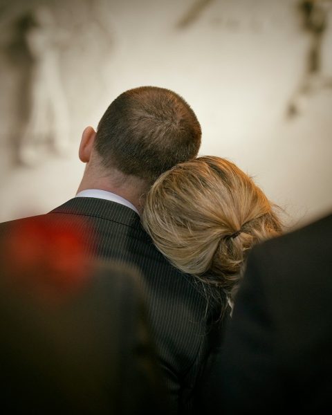 a man and a woman looking at the camera