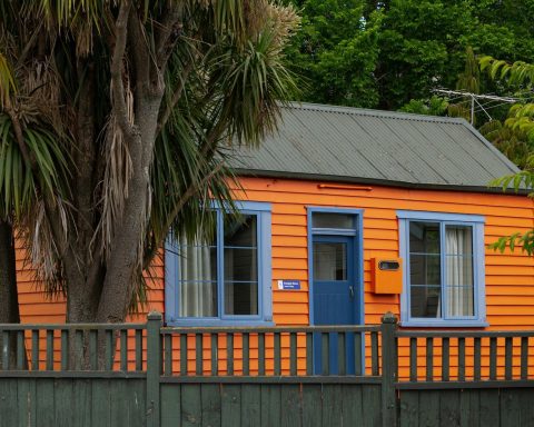 a small orange house with a blue door