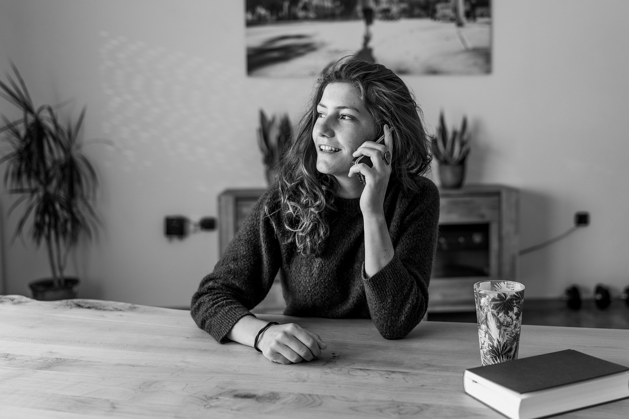 Een oudere vrouw praat gezellig met een buurvrouw op de stoep